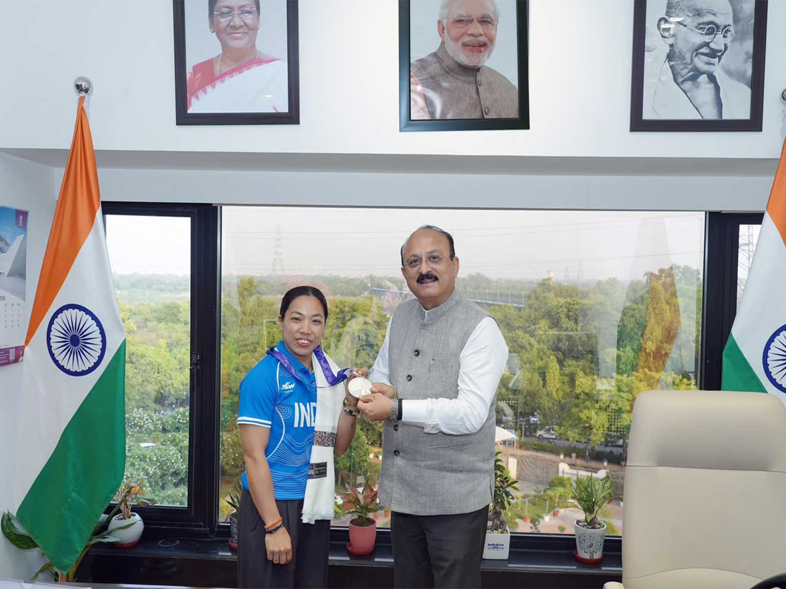 Weightlifter Mirabai Chanu (L) showing her Asiad silver medal to Ashish Sood in New Delhi. (Photo: X/ @ashishsood_bjp)