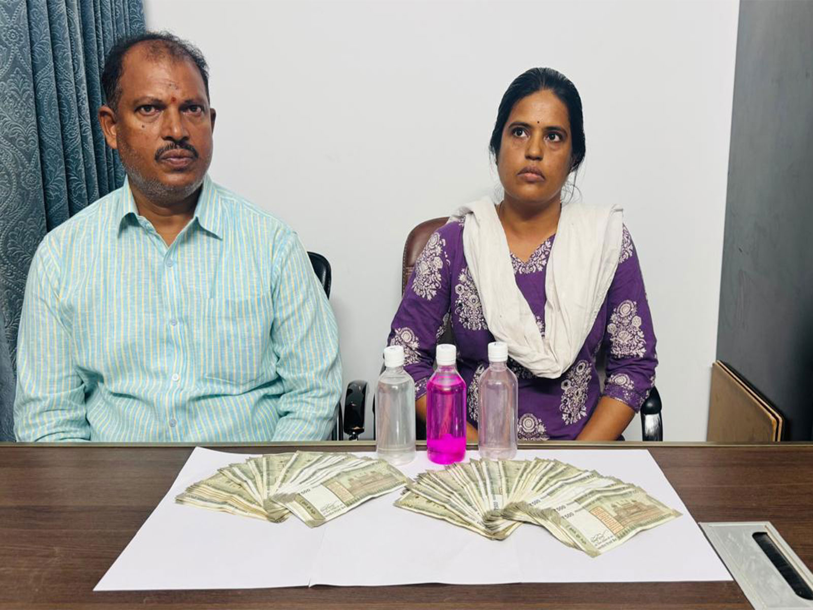 Telangana ACB officials catch Moinabad Municipality Town Planning Officer Gundu Vani and Senior Assistant Yelamoni Sudarshan in connection with an alleged Rs 75,000 bribe case. (Photo: Telangana ACB)