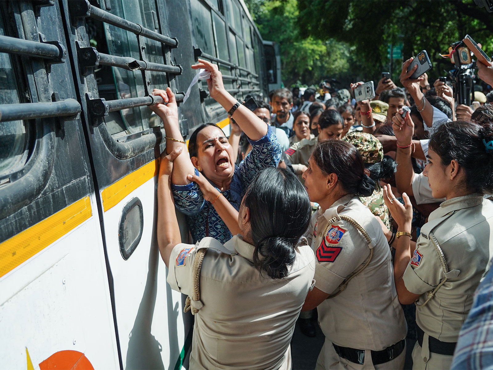 Police personnel detain a protester during a protest near Jantar Mantar, in New Delhi (File Photo/ANI)