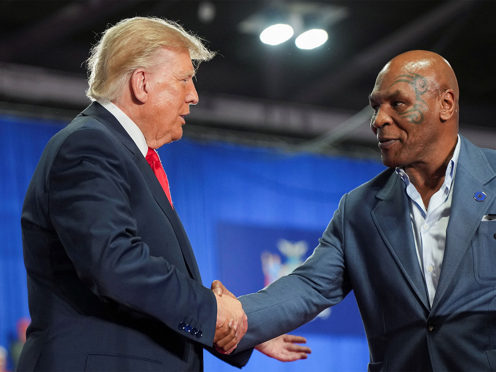 US President Donald Trump shakes hands with former professional boxer Mike Tyson. (Photo: Reuters)