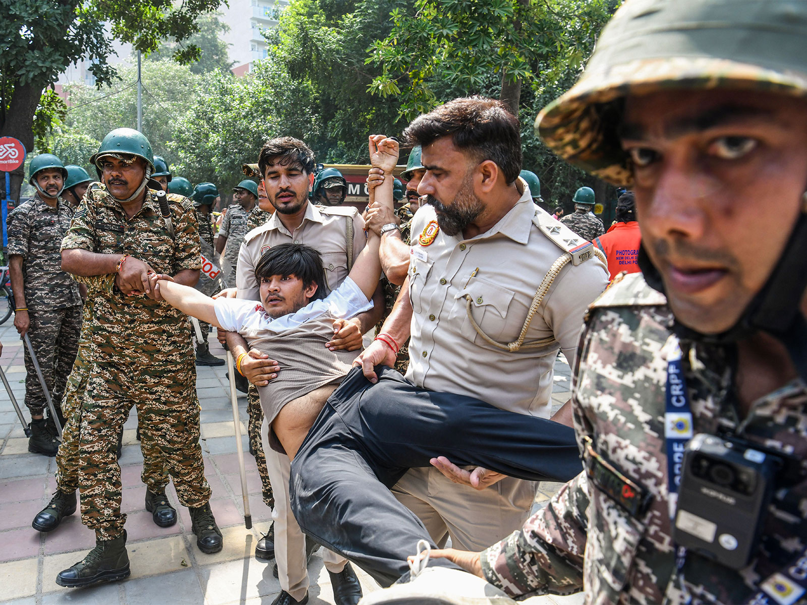 Delhi Police detains a protester near the Gol Dak Khana area (Photo/ANI)