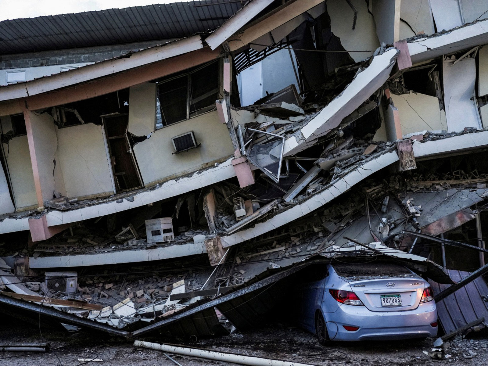A car sits crushed beneath debris from a collapsed building after an earthquake struck near the southern coast of Panama (File photo/Reuters)