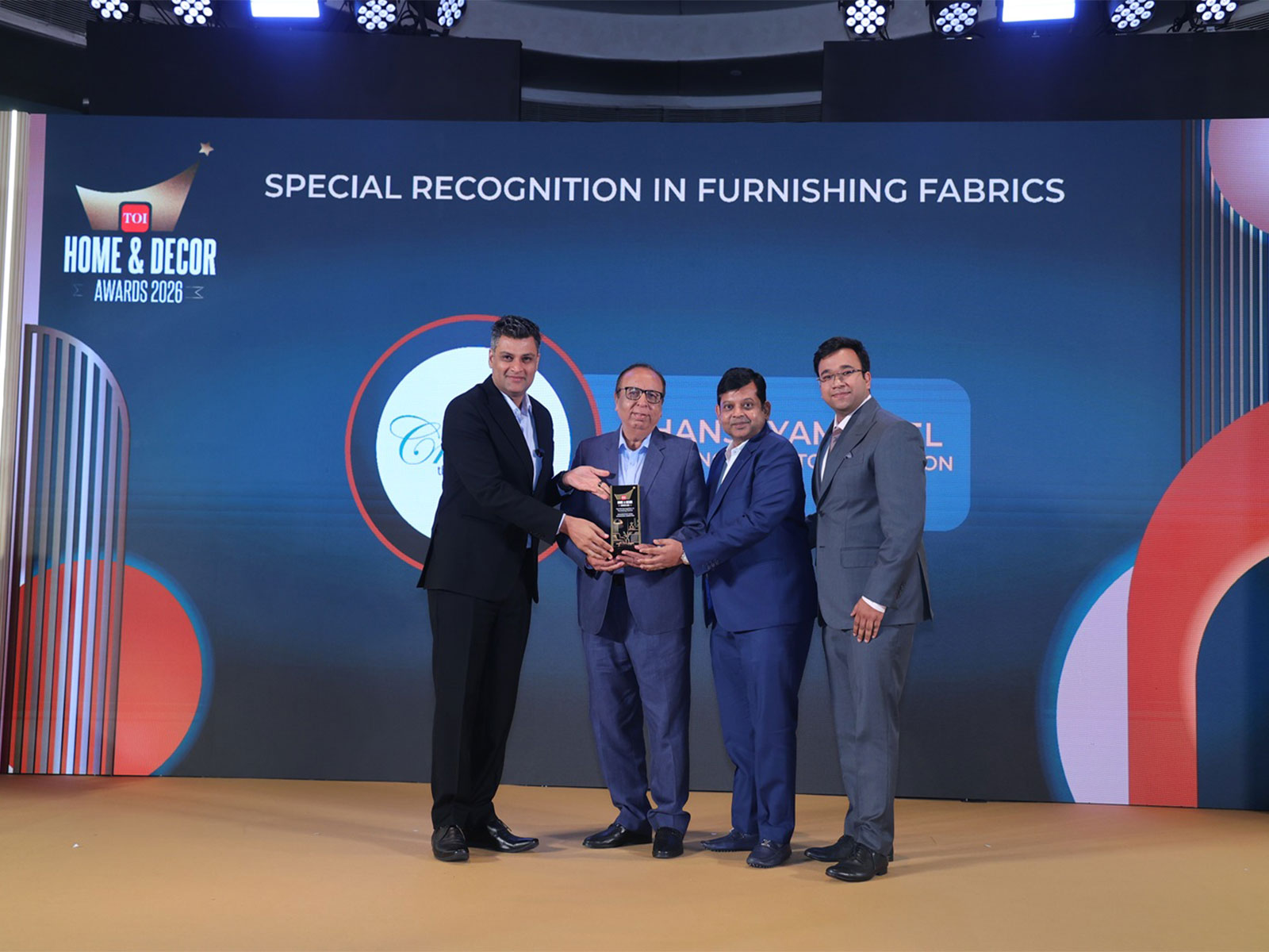 Ghanshyam Goel, Shivam Goel and Narender Gupta, MDs, Creation Furnishings, receive Special Recognition Award in Furnishing Fabrics from Ravi Kewalramani at the 2026 TOI Home & Decor Awards.