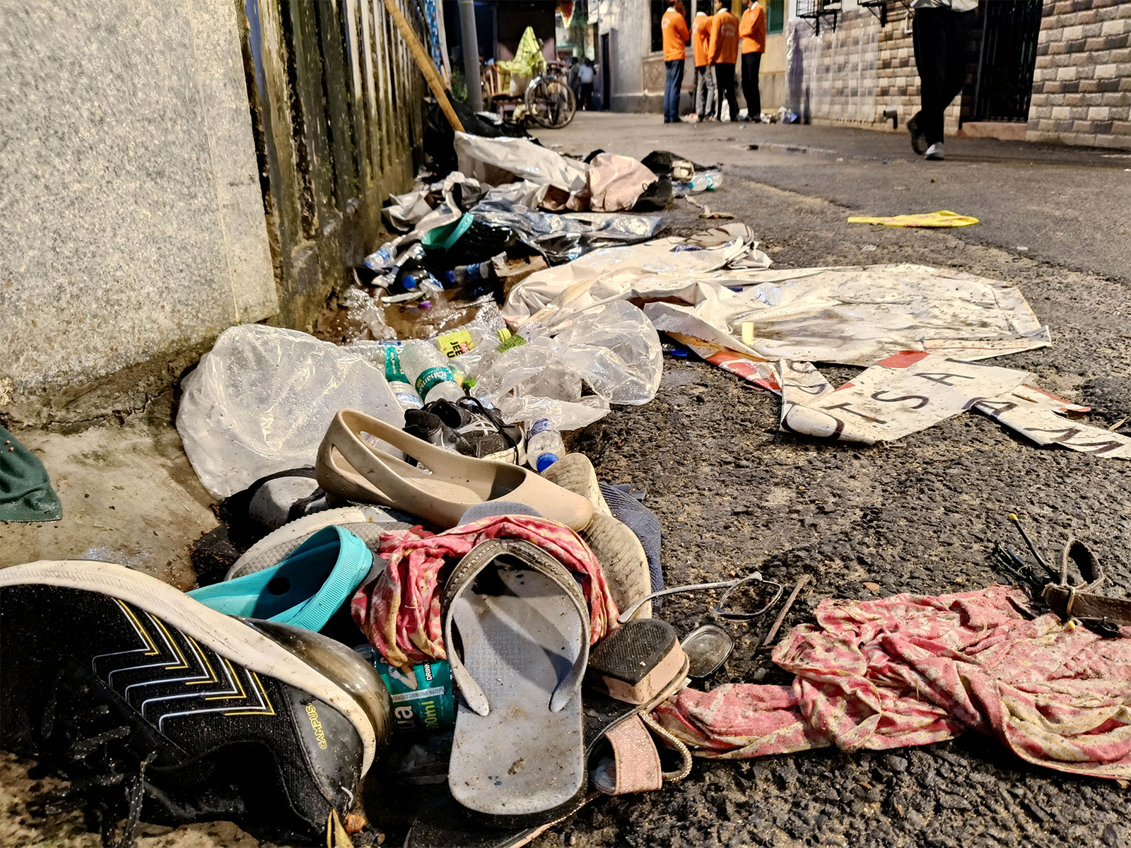 ootwear and other items lie scattered at the site after a stampede-like situation at the Chorbagan Sarbojanin Durga Puja pandal (Photo/ANI)