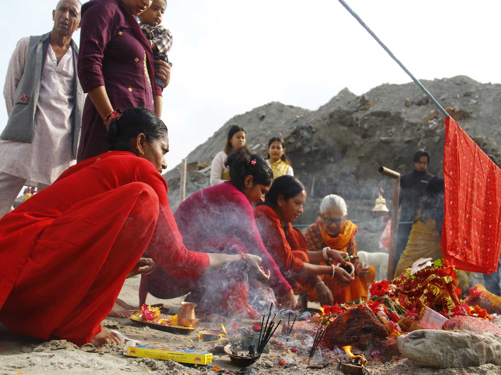 Devotees perform rituals and offer prayers using holy stones ("Shila") at the site of destroyed shrines in Devighat, Nuwakot district, following the August 26 flash flood (Photo/ANI)