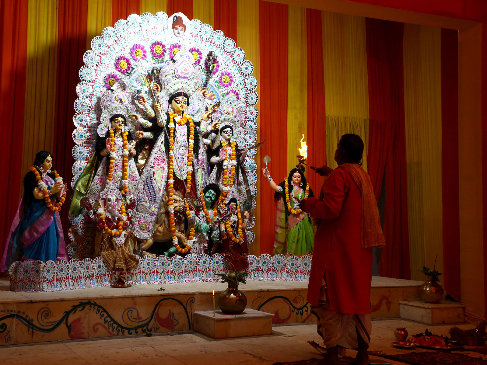 A priest performs Arti at the decorated Puja Pandal on 'Maha Sashti' during Navratri festival at CR Park (File Photo/ANI)