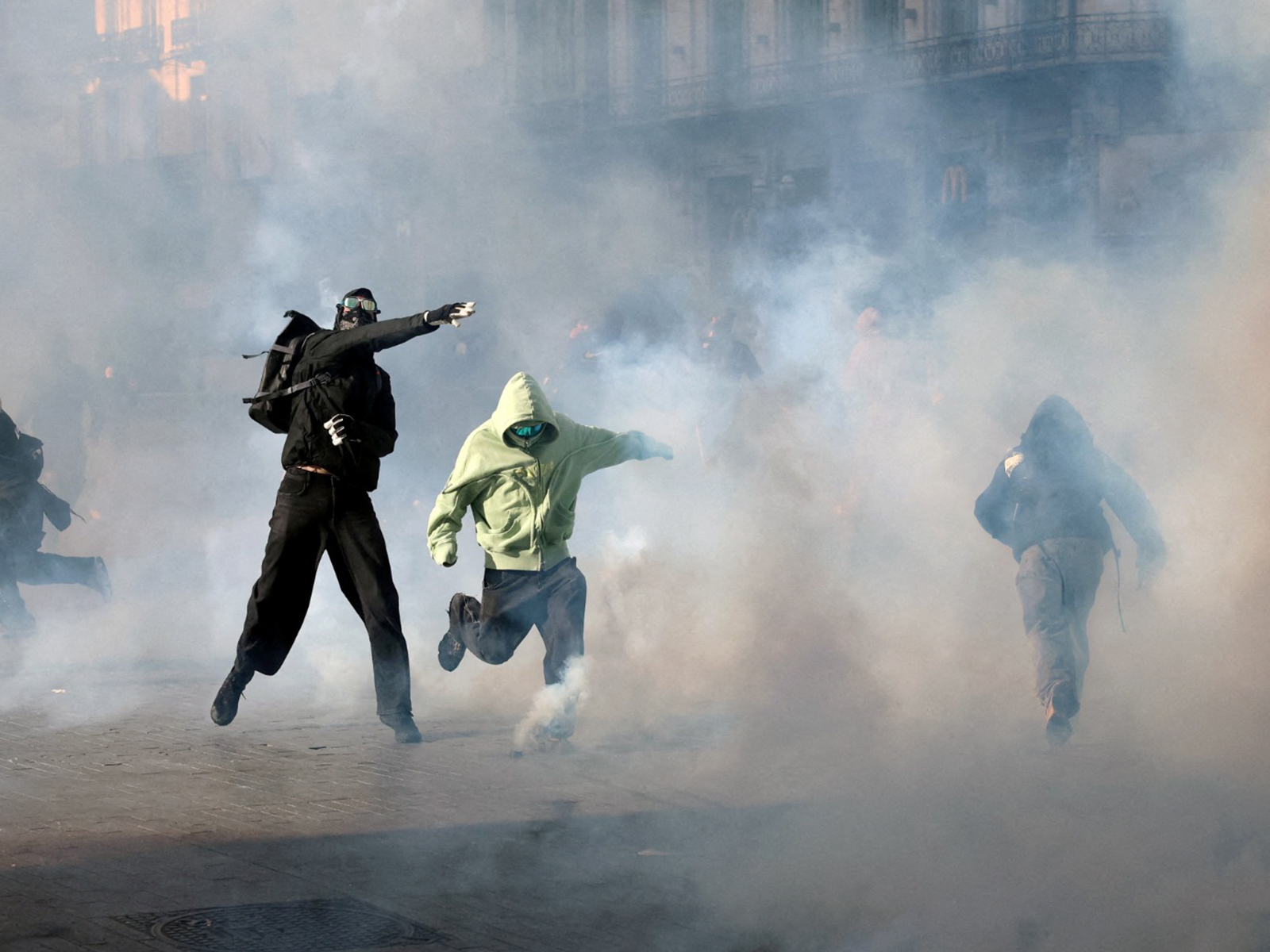 Demonstrators react to tear gas fired by police during a students' protest in Brussels, Belgium (Photo/Reuters)