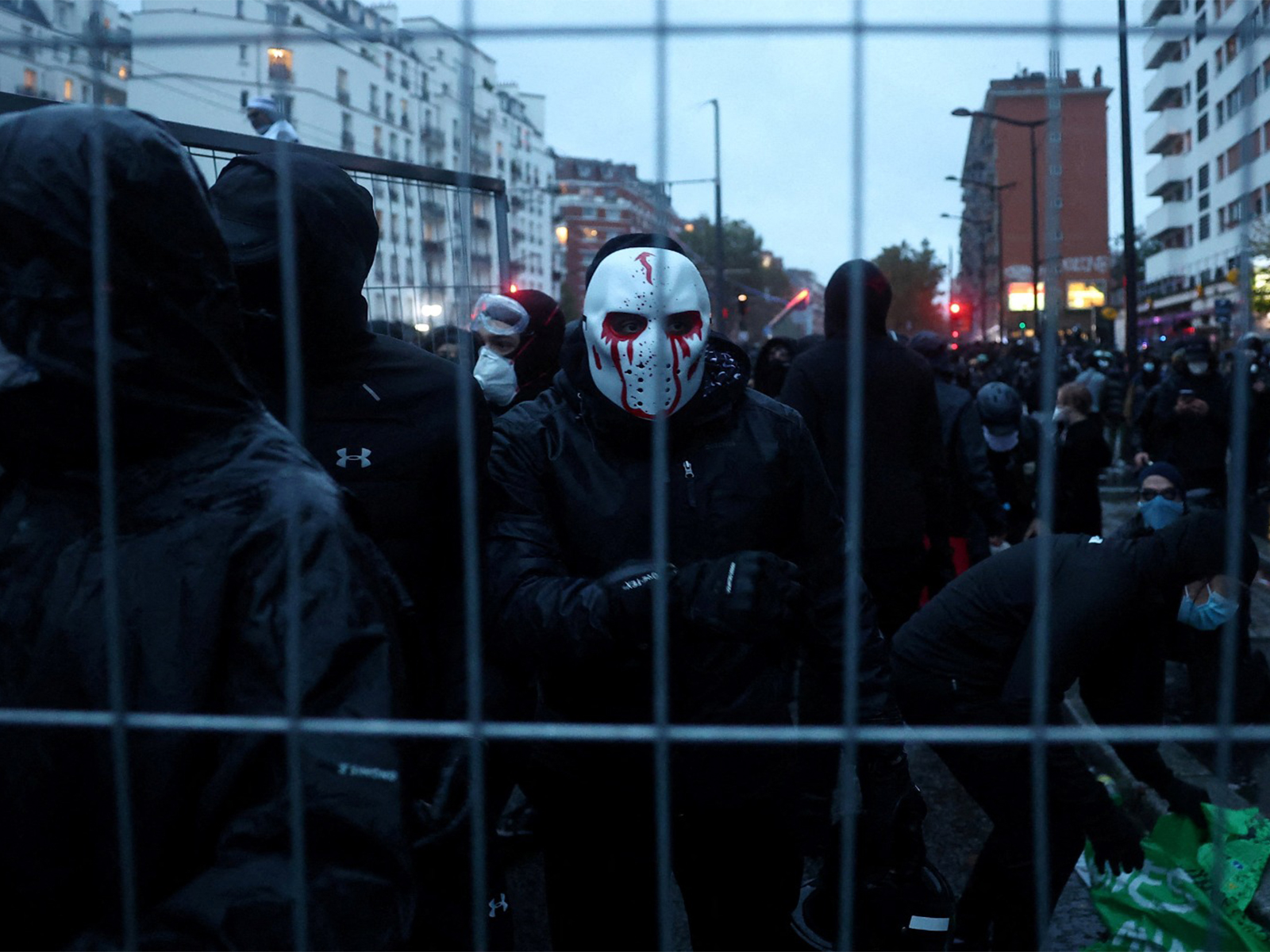 Masked protesters install a barricade amid clashes with French police during demonstration organised by labour unions in Paris as part of nationwide protests called by the Yellow Vests movement (Photo/Reuters)