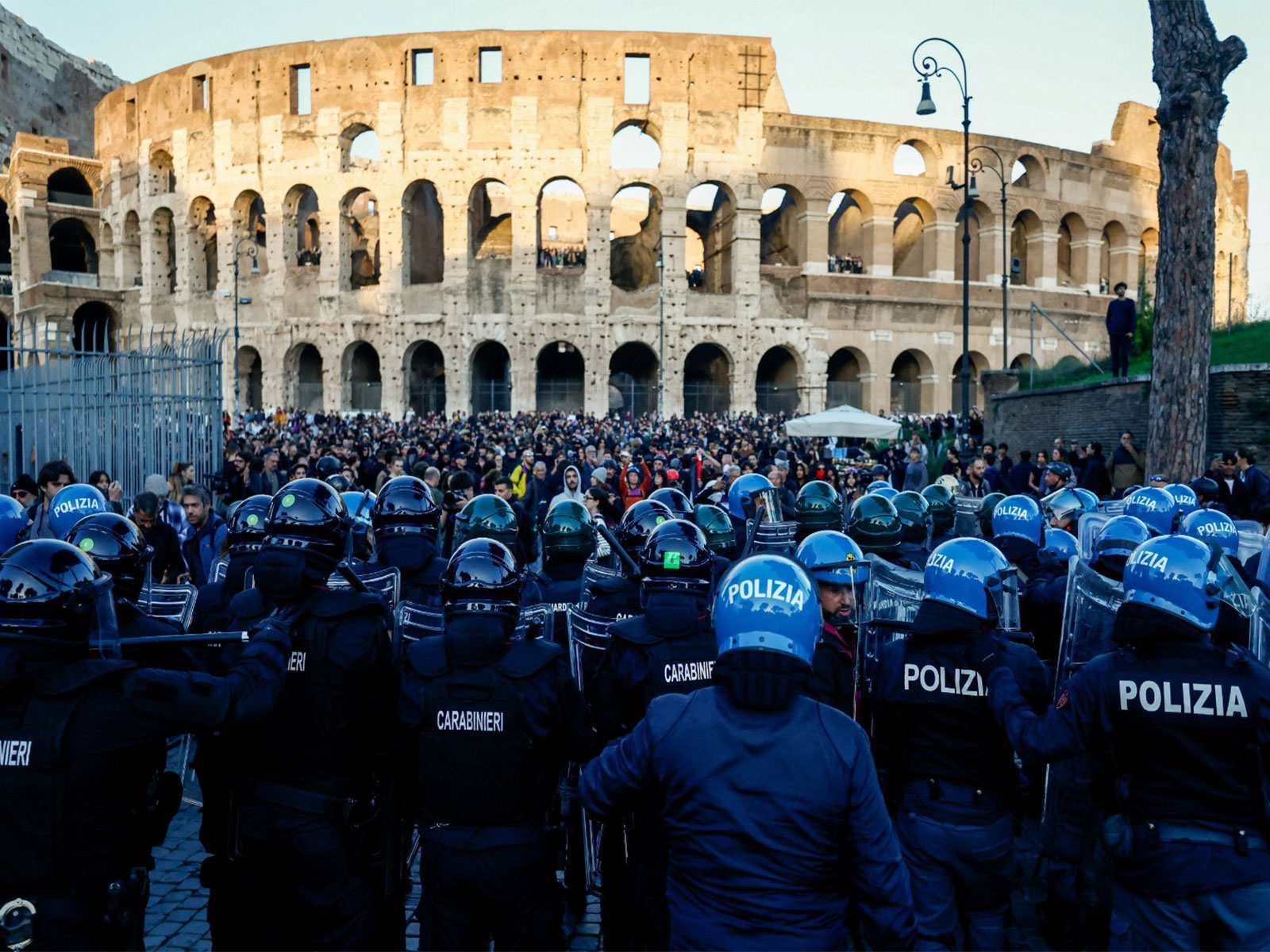 Police and Carabinieri officers line up outside the Colosseum as people join demonstrations in Rome (Photo/Reuters)