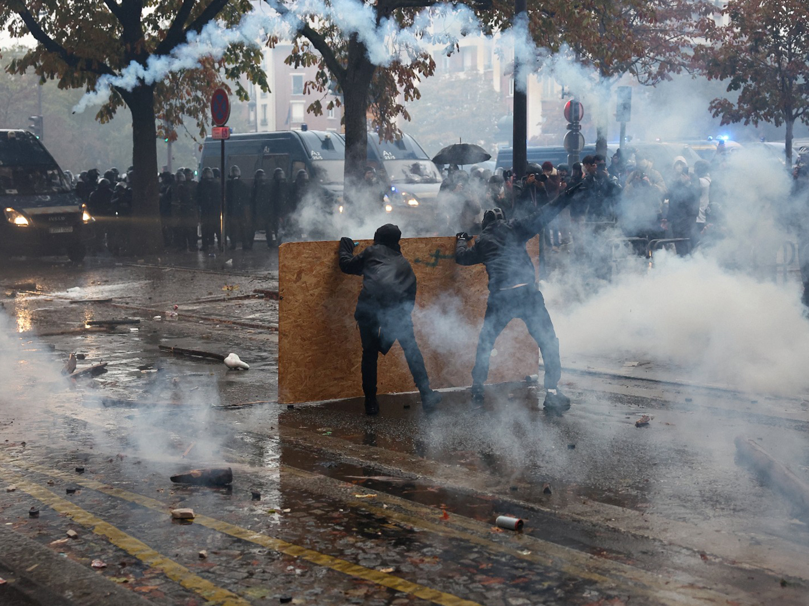 Demonstrators react to tear gas fired by police during cost-of-living protest in France (Photo/Reuters)