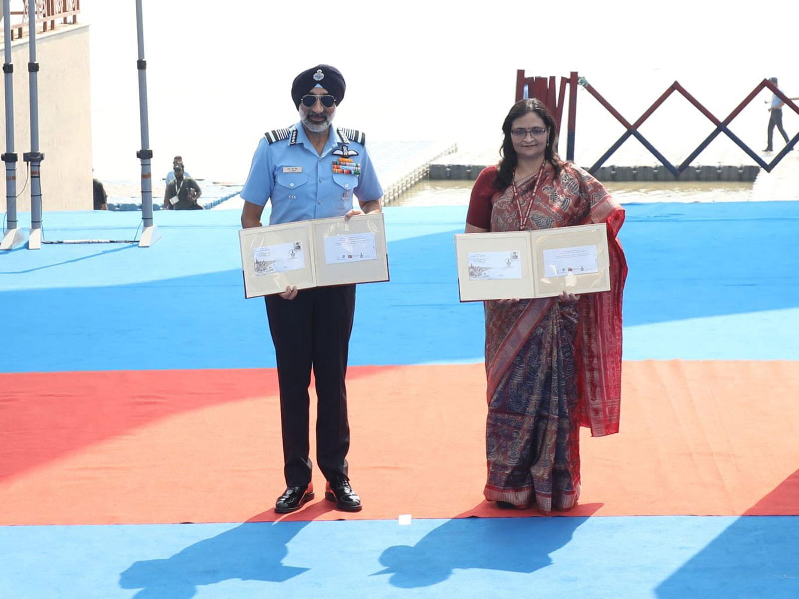 Air Chief Marshal AP Singh releases a special cover during the IAF aerial display at Namo Ghat in Varanasi (Photo/X/@CAC_CPRO)
