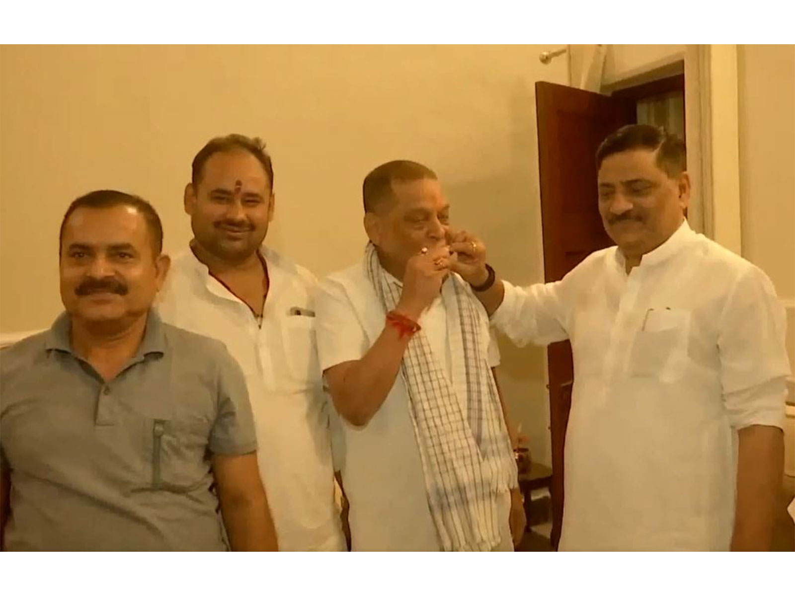 JD(U)'s Umesh Kushwaha congratulates newly elected MLC Neeraj Kumar with sweets following his win in the Bihar Legislative Council elections (Photo/ANI)