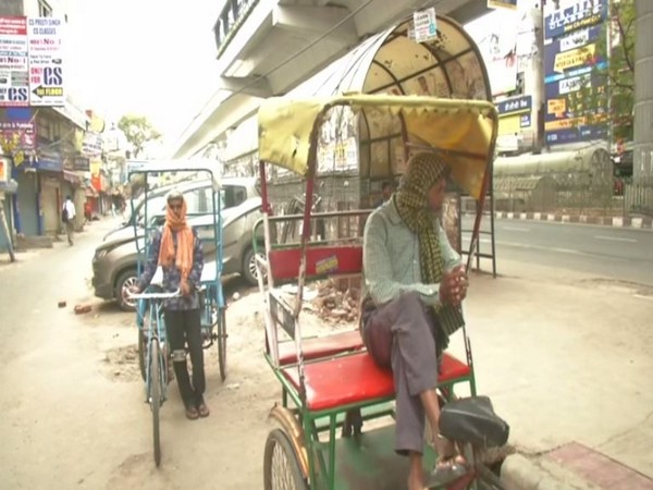 Two rickshaw pullers wait for customers amid lockdown in the national capital. Photo/ANI Two rickshaw pullers wait for customers amid lockdown in the national capital. Photo/ANI