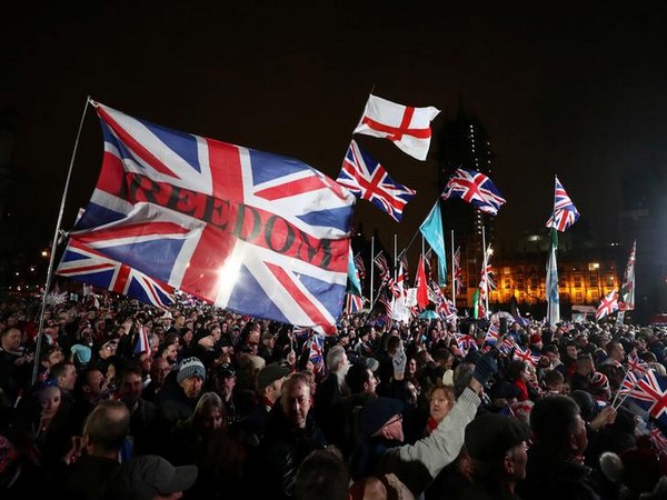 Pro-Brexit demonstrators celebrate on Parliament Square on Brexit day in London. Pro-Brexit demonstrators celebrate on Parliament Square on Brexit day in London.