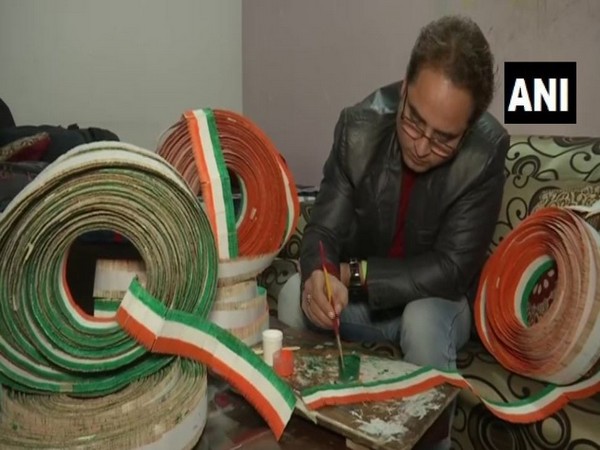 Baljinder Singh giving final touches to the national flag, which he has made by using 71,000 toothpicks, in Amritsar on Thursday. Photo/ANI