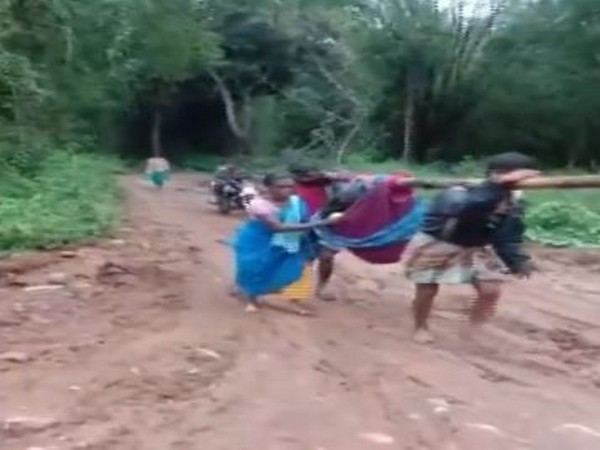The pregnant woman being carried in a cloth cradle by her husband and another villager in Burgur village, Erode, in Tamil Nadu on Tuesday. Photo/ANI The pregnant woman being carried in a cloth cradle by her husband and another villager in Burgur village, Erode, in Tamil Nadu on Tuesday. Photo/ANI