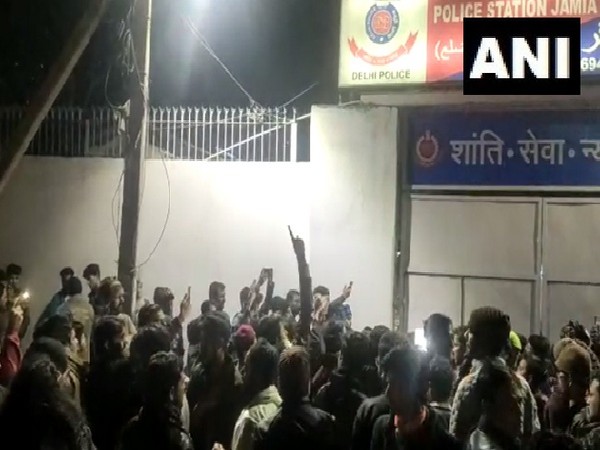 People gather outside Jamia Nagar police station in New Delhi following firing near the university. People gather outside Jamia Nagar police station in New Delhi following firing near the university.
