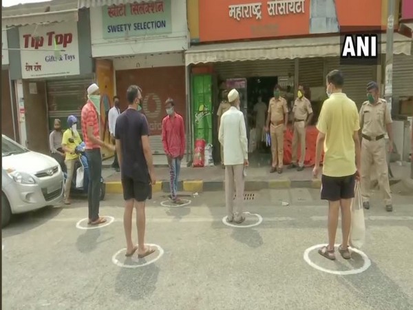 People standing in separate circles marked with chalk while collecting basic supplies from a grocery shop at Andheri East on Wednesday. Photo/ANI People standing in separate circles marked with chalk while collecting basic supplies from a grocery shop at Andheri East on Wednesday. Photo/ANI