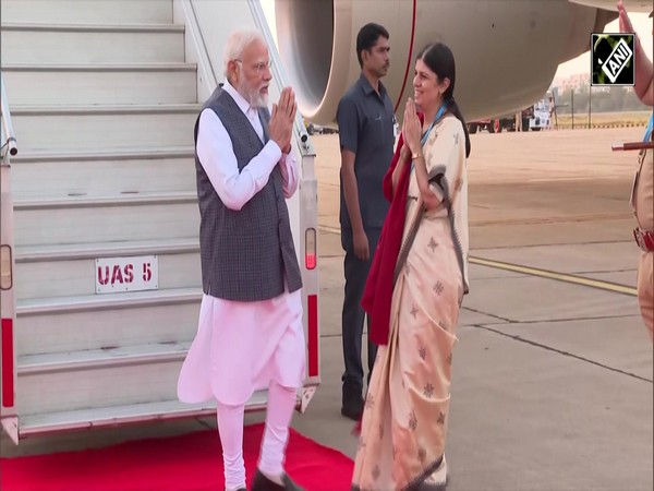 PM Narendra Modi greets people gathered outside HAL Airport in Bengaluru